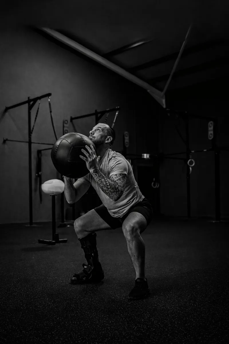 Mark Lynch training in a gym, working through a set with focus and determination